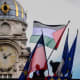 An employee places the Palestinian flag alongside other flags at the Lyon City Hall on Sept. 22, 2025, as more than 50 town halls in France flew the Palestinian flag in defiance of an interior ministry warning not to do so.