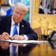 President Donald Trump signs an executive order in the Oval Office on Sept. 19, 2025 ,establishing the “Trump Gold Card” and introducing a $100,000 fee for H-1B visas.
