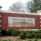 The sign for Tennessee State University on a brick facade outside