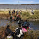 Migrants, predominantly from Venezuela, cross the Rio Grande