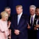 Pastor Paula White, third from left, and other faith leaders pray with President Donald Trump.