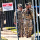 National Guard members walk around outside of the U.S. Immigration and Customs Enforcement holding facility.