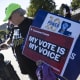 Demonstrators hold signs in support of minority voting rights outside the U.S. Supreme Court on.