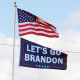 A "Let's go Brandon" flag flies below the American flag.