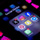 Mobile phone screens display Instagram's logo and a social media folder with X, Instagram, Facebook, Pinterest, Snapchat, Telegram and Whatsapp applications.