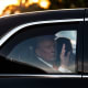 U.S. President Donald Trump waves from the Presidential limousine.