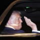 US President Donald Trump waving from his presidential car.