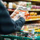 A shopper looks at a sales advertisement at a grocery store.