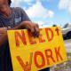 Man works a street corner hoping to land a job.