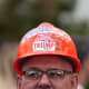 An attendee wearing a hard hat decorated with "Trump" stickers during an event in the Rose Garden at the White House.