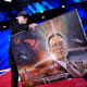Elon Musk holds a painting of himself.