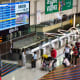 Travelers wait in line to check in for flights at the Simón Bolívar International Airport in Venezuela.