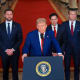 President Donald Trump speaks at a lectern at the White House