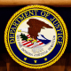 The Department of Justice seal and logo are displayed at the Department of Justice.