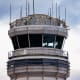 An American Eagle plane takes off near the air traffic control tower.