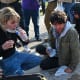 Demonstrators protesting outside the U.S Immigration & Customs Enforcement facility, including Democratic congressional candidate Kat Abughazaleh, left, react after being tear-gassed in Broadview, IL.