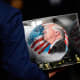 A person carries a soccer ball with a painting of President Donald Trump in D.C.