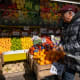 A man walks by a food market in New York City.