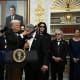 Actor Sylvester Stallone receives a medal from President Donald Trump during the Kennedy Centre Honors medal presentation ahead of tomorrow’s ceremony, in the Oval Office of the White House on Dec. 6, 2025.