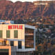 An aerial view of the Netflix logo displayed at Netflix studios, with the Hollywood sign in the distance, on Dec. 5, 2025, in Los Angeles.