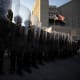 National guards stand in front of the entrance of the Metropolitan Detention Center as demonstrators gather in front of it following federal immigration operations in Los Angeles, CA.