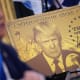 A poster of the “Trump Gold Card” is seen as President Donald Trump delivers remarks