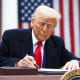 President Donald Trump signs an executive order on April 2, 2025, in the Rose Garden of the White House.