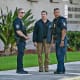 Security and law enforcement officials stand outside the Paul G. Rogers Federal Building and US Courthouse