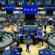 Traders work on the floor of the New York Stock Exchange at the opening bell in New York.