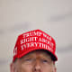 President Donald Trump wears a hat that reads "Trump was right about everything."