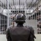 A prison officer guards a cell at the maximum-security penitentiary CECOT on April 4, 2025, in El Salvador.