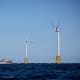 A boat passes in front of the Ørsted Block Island Wind Farm off Block Island, R.I., on Sept, 14, 2016.