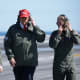 President Donald Trump observes naval flight demonstrations on the deck of the USS George H.W. Bush aircraft carrier.