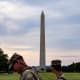 Two National Guardsmen walk in front of the Washington Monument