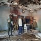 People inspect the scene of a deadly bomb explosion inside a mosque on Dec. 25 in Maiduguri, Nigeria.