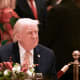 US President Donald Trump attends a Christmas dinner on Dec. 24 at his Mar-a-Lago resort in Palm Beach, FL.