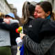 Prarie Summer, a USAID contractor for almost 10 years, right, cries as she embraces a Alexandra Jung after leaving the agency's former offices at the Ronald Reagan Building and International Trade Center.