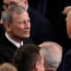 President Donald Trump greets Chief Justice John Roberts before he addresses a joint session of Congress at the U.S. Capitol.