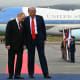 Donald Trump stands next to Vladimir Putin on the tarmac
