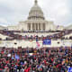 A mob of people gather outside the Capitol building.