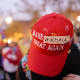 A red MAGA cap with the word "Venezuela" taped over "America"