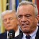 RFK Jr. speaks in the Oval Office while President Trump looks on.