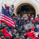 A police office sprays tear gas on a crowd of pro-Trump supporters attempting to enter the Capitol.