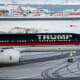 A plane with "TRUMP" written on the side sits on a snowy tarmac.
