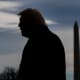 A silhouette of President Donald Trump on the South Lawn of the White House.