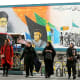 Women in Tehran walking down the street in this wide frame shot from below.