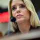 A close up of Pam Bondi behind a microphone.