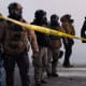 Federal agents stand in tear gas and face protesters on Nicollet Avenue near West 26th St. in Minneapolis, Minn. on Saturday, Jan. 24, 2026.