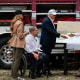 Donald Trump shakes hands with an official at the disaster scene after the deadly flooding in the area.