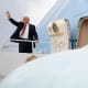 Donald Trump waves on the top step leading into Air Force One.